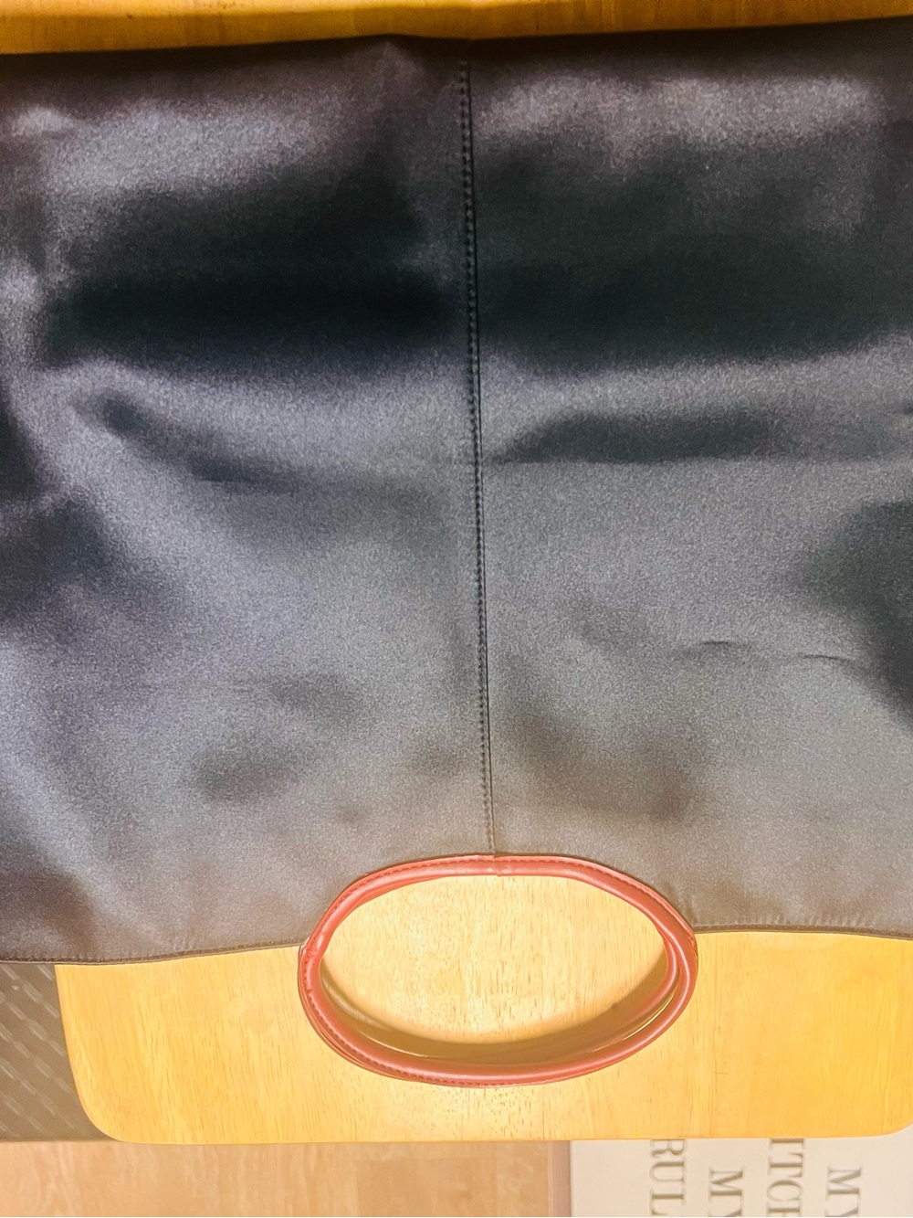 Sleek Black Tote with Red Oval Handles